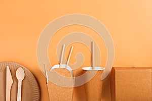 Eco-friendly tableware and food packaging on a beige background