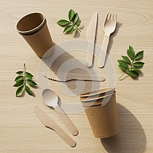 Eco-friendly tableware set on a light wooden surface includes compostable brown