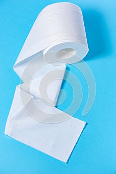 Eco-friendly white toilet paper on a blue background close-up