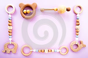 Eco-friendly wooden children`s toys on a pink background, top view, flat layout, copy space. Flat composition, baby background