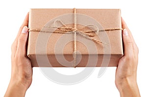 Eco gift box from kraft paper in hand isolated on white background