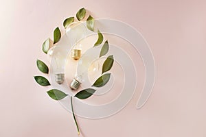 Eco green energy concept bulb, lightbulb leaves on pink background