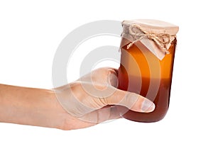 Eco home made honey in jar in hand isolated on white background