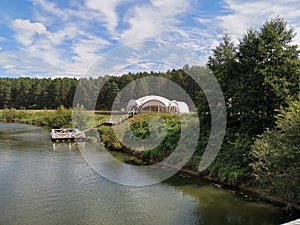 Eco hotel in the form of a transparent sphere in the middle of a dense pine forest. Ecotourism.