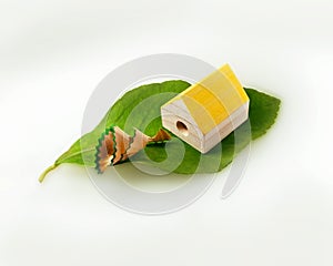 Eco house. Alternative zero emission energy concept with house shaped pencil sharpener. Emission of clean waste