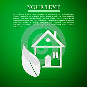 Eco House flat icon on green background
