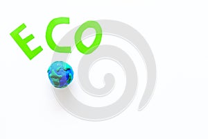 Eco icon cutout near planet Earth plastiline symbol on white background top view copy space