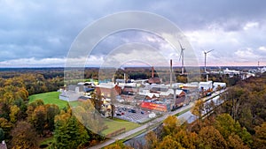 Eco-Industrial Evolution: Wind Turbines Overlooking a Factory