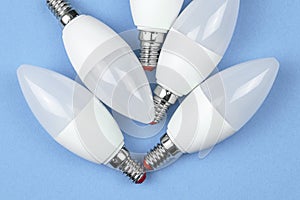 Eco LED light bulbs, pastel blue background. Energy saving concept. Flat lay, top view, copy space photo