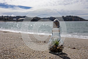 Eco Light Bulb stands on the ocean.