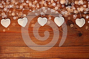 Eco linen fabric hearts on wooden background,Valentines Day concept design.Decorative white heart on jute twine garland