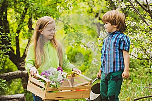 Eco living. Happy children farmers having fun on spring field. Children farmer in the farm with countryside background