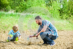 Eco living. happy earth day. Family tree. father and son planting flowers in ground. new life. soils fertilizers. rich