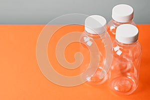 Eco plastic bottles on colour background.
