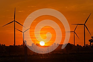 Eco power in wind turbine farm with sunset