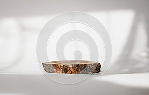 Eco rustic pine tree wood disc platform podium on white light and shadow copy spase background. Minimal empty display product