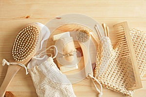 eco set for self-care, bamboo and tin items, cotton sponges and homemade soap on a wooden background