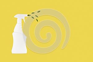 Eco spray bottle for safe cleaning with green leaves