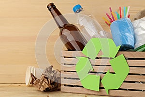 Eco symbol and trash in the box. recycling. waste recycling. on natural wooden background