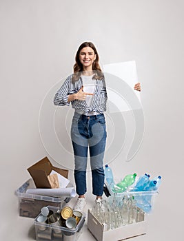 Eco-Volunteer Woman With Blank Placard Standing Among Containers With Different Sorted Waste