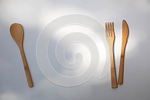 Eco wooden cutlery, spoon, fork, knife on a white background. Top view