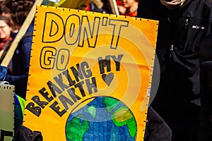 Ecological activist holds sign at rally