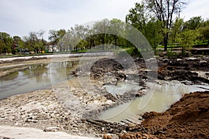 Ecological catastrophy. Drying lake in city park. Dry swamp lake disappears, idea and concept of environmental conservation,