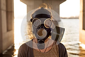 Ecological concept of air contamination. Woman in gas mask