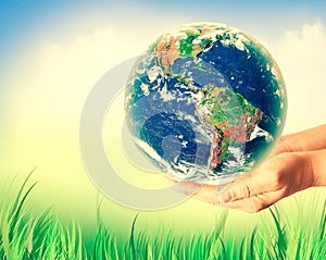 Ecological concept of the environment with the cultivation of trees on the ground in the hands. Planet Earth. Physical