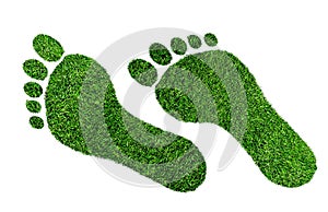 Ecological footprint concept, barefoot footprint made of lush green grass photo