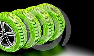 Ecological green tires on dark background