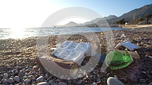 Ecological problem and environmental pollution concept. Scattered trash on the beach. Empty used dirty plastic bottles