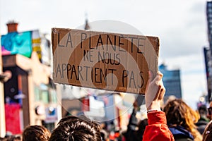 Ecological protestor holds French sign