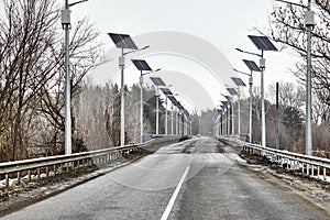 Ecological street lighting.Asphalt road on the bridge. Solar bridge road lighting. Landscape with a road