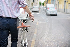 Ecological transport concept , man holding bicycle in the city street