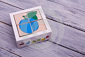 Ecological wooden cubes with fruits. Colorful geometric figures on the wooden background.