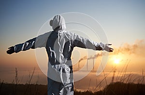 Ecologist spreading hands to sides at thermal power station.