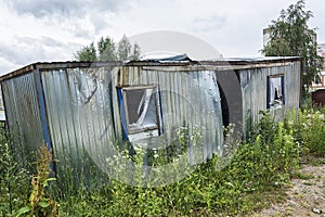 Ecology. The abandoned broken-down construction booth was overgrown with grass.