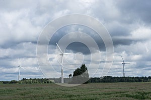Ecology concept: Blue sky, white clouds and wind turbine. Wind generator for electricity, alternative energy source.