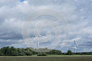 Ecology concept: Blue sky, white clouds and wind turbine. Wind generator for electricity, alternative energy source.