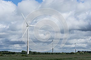 Ecology concept: Blue sky, white clouds and wind turbine. Wind generator for electricity, alternative energy source.