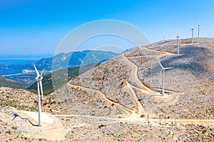 Ecology concept. Wind turbines in the mountains on the Kefalonia island, Greece. Aerial drone view