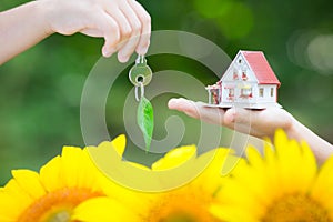 Ecology house and key in hands