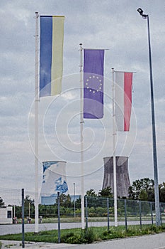 Economic crisis flags on power plant background