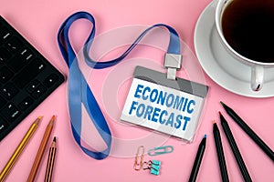 ECONOMIC FORECAST concept. Staff Identity, colored pencils, black computer keyboard and a cup of coffee