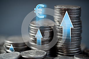 Economic growth in the European Union. Stacks of coins with up arrows and euro sign.