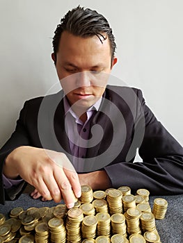 economic growth, young businessman stacking mexican coins of ten pesos