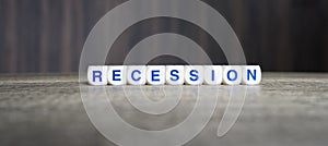 Recession boggle word cubes on dark background photo
