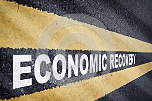 Economic recovery word on asphalt road with marking lines for giving directions