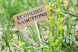 Economic sanctions wooden sign photo
